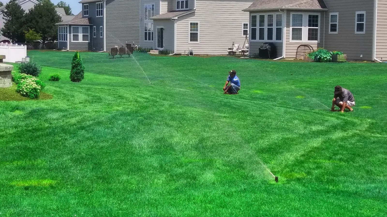 Technicians checking irrigation coverage
